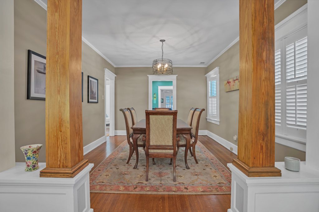 View of a dining room framed by two elegant wood columns, highlighting an open layout as part of a prep to sell Louisville home.